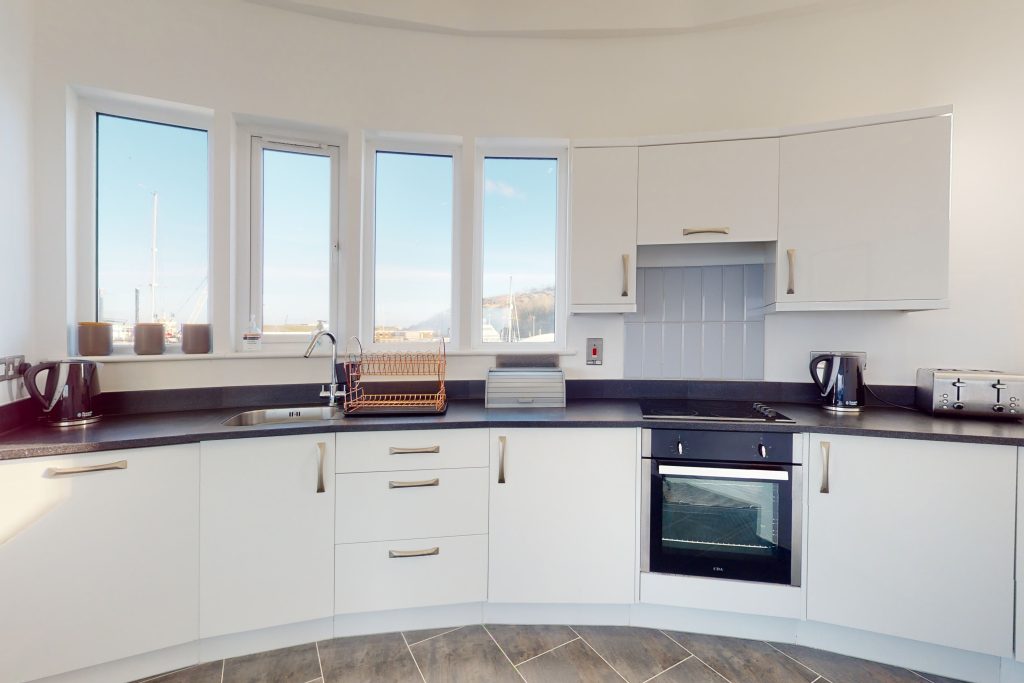 Perched on the waterfront, overlooking the harbour and marina, the apartment boasts one of the most captivating vistas in the county.